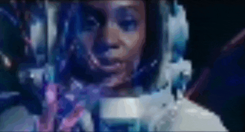 a close up of a woman in an astronaut 's helmet in space .