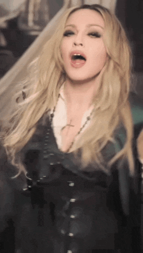 a woman with blonde hair and a cross necklace