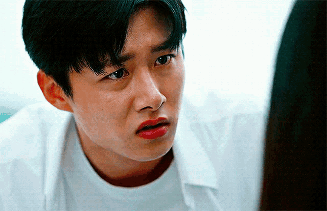 a man with red lipstick on his lips looks at another man