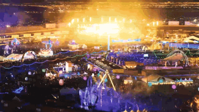 an aerial view of a carnival at night with a large stage in the middle