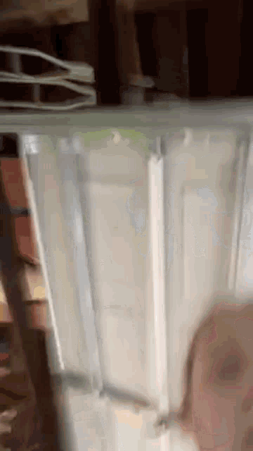 a clear plastic container is sitting on top of a wooden table in a room .