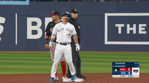 a blue jays player is standing on the base