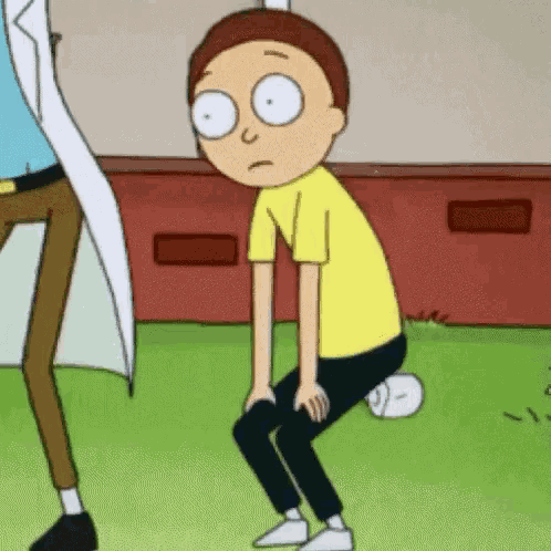 a cartoon character is squatting down on the grass .