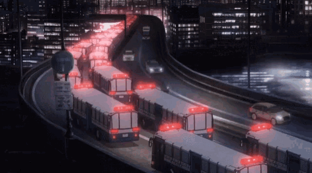 a row of emergency vehicles are driving down a highway
