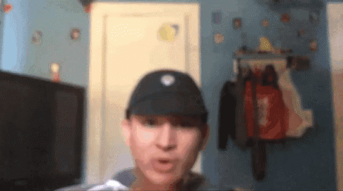 a blurry picture of a man wearing a black hat