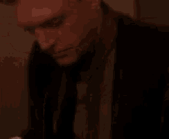 a man and a woman are standing next to each other in a dark room .