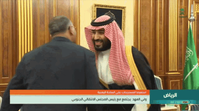 a man in a saudi arabian costume is being interviewed