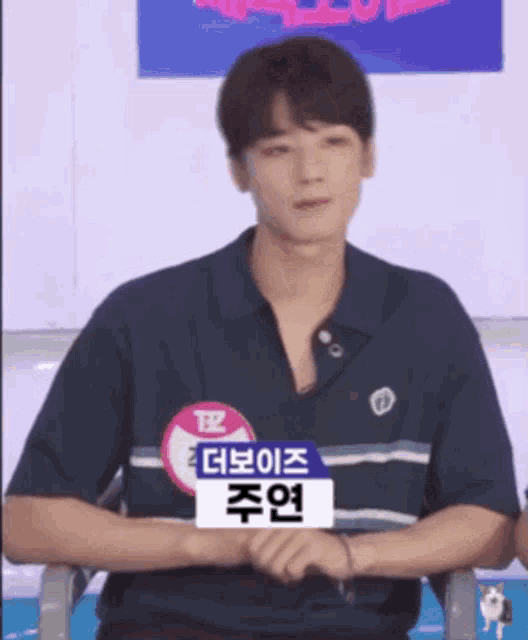 a young man wearing a name tag with the letters tz on it