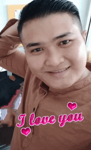 a man wearing a brown shirt with the words " i love you " written on it