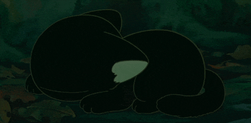 a cartoon cat is sleeping in the dark