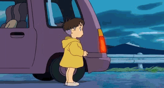 a little girl in a yellow raincoat is standing next to a purple car