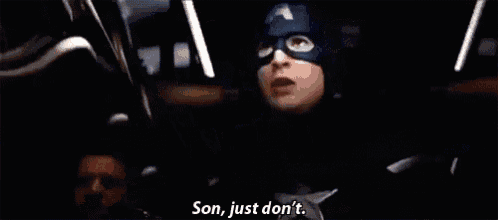a man in a captain america costume is talking to another man .