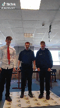 three young men are standing in a room with tiktok written on the bottom right corner