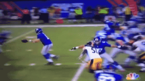 a football player with the number 52 on his jersey is being tackled by other players