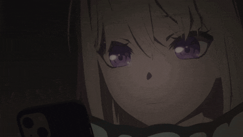 a girl with purple eyes looks at a cell phone