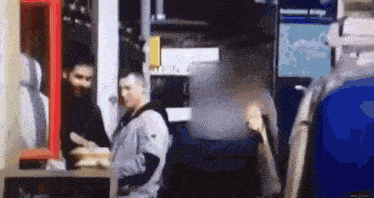 a group of people are standing in front of a mcdonald 's restaurant