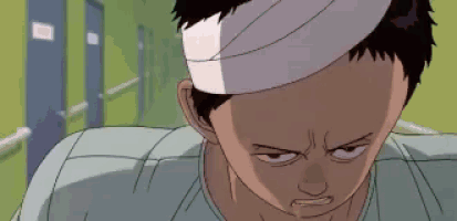 a man with a bandage on his head looks at the camera