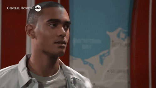 a man is standing in front of a sign that says general hospital abc