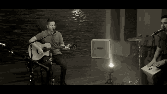 a man singing into a microphone with a beard
