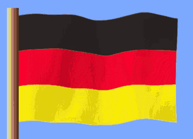 a german flag is waving in the wind on a blue background