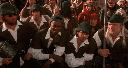 a group of people dressed in robin hood costumes are sitting in a line .