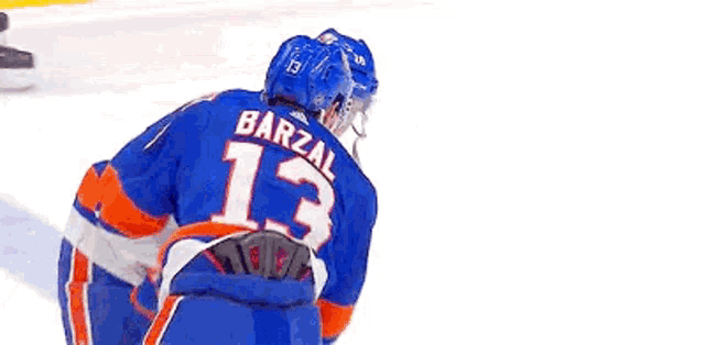 a couple of ice hockey players are hugging each other on the ice .