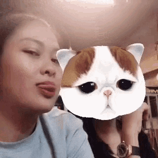 a woman with her tongue out and a cat mask on her face