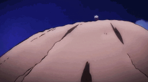 a person standing on top of a hill with a blue sky in the background .