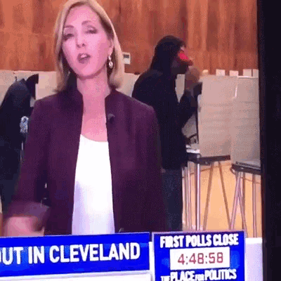 a woman is standing in front of a sign that says " first polls close "