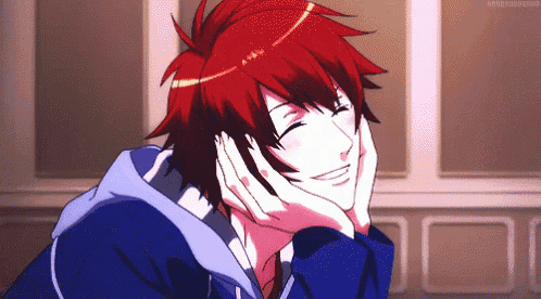 a man with red hair is smiling with his hands on his face ..