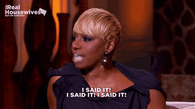 a woman is sitting on a couch and says i said it i said it