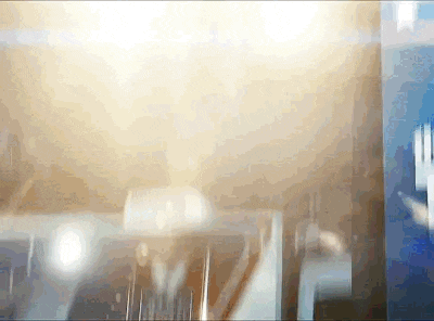 a blurry picture of a building with the sun shining through the windows