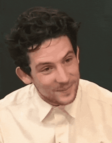 a close up of a man 's face wearing a white shirt .