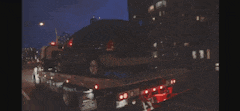 a car is being towed by a tow truck that says drop a fifty bag for the mob in the sky