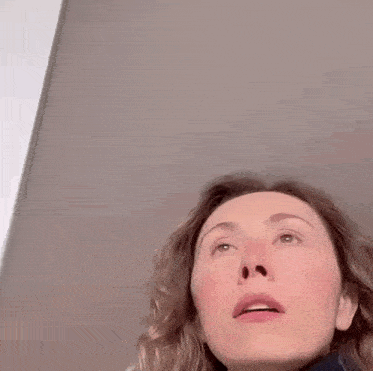 a close up of a woman 's face with a slight smirk on it .