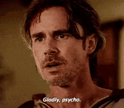 a man with blood on his forehead is saying gladly psycho .