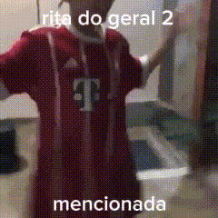 a man wearing a red t-mobile jersey is standing in a room .