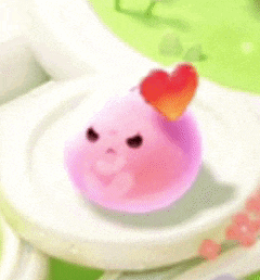 a pink object with a heart on top of it is on a plate .