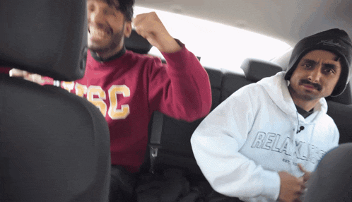 a man wearing a sweatshirt that says ' relax ' on it