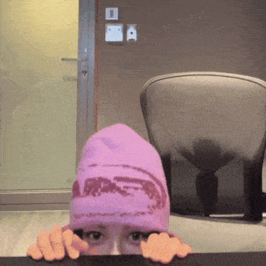a person wearing a purple hat that says a on it