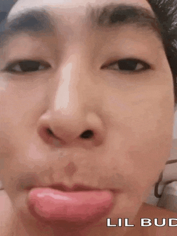 a close up of a person making a funny face with their tongue out .