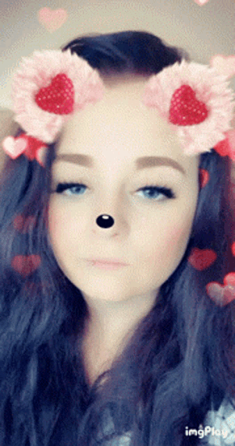 a close up of a woman 's face with hearts and flowers on her head