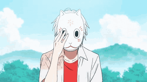 a man wearing a cat mask is standing in front of a blue sky