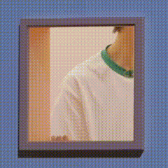 a picture of a person in a white shirt with a green collar in a frame