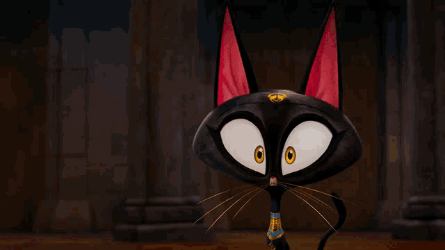 a black cat with red ears and yellow eyes looks at the camera