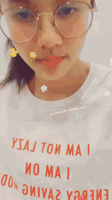 a woman wearing glasses and a t-shirt that says ysaj ton mai