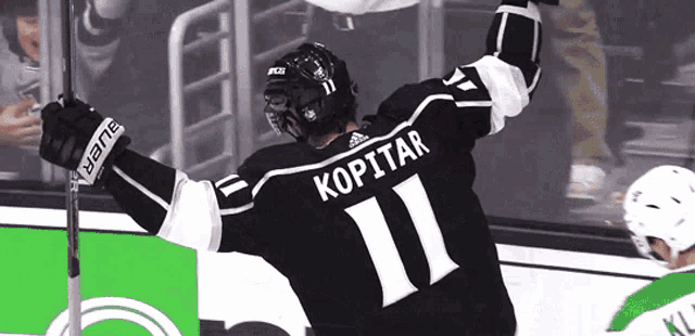 a hockey player wearing a jersey with the number 11 on it