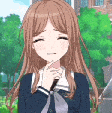 a girl with long brown hair is smiling with her eyes closed and her hand on her chin