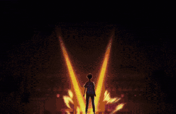 a silhouette of a person standing in front of a fire explosion