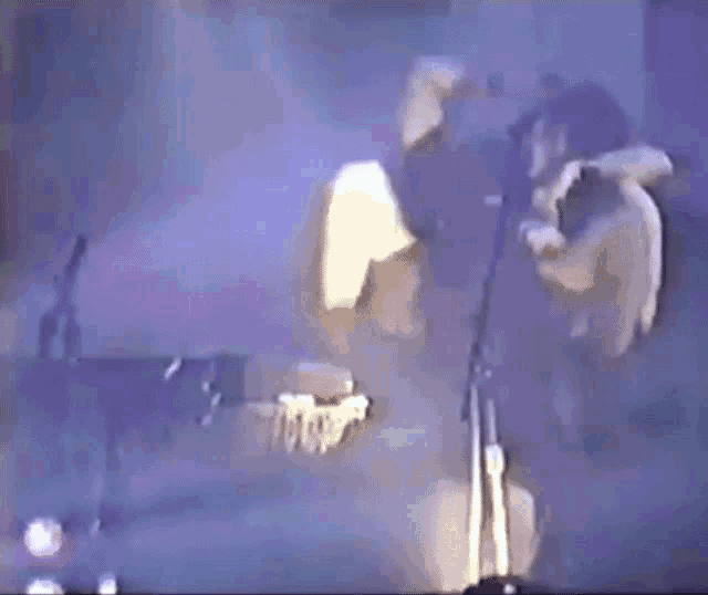 a blurry picture of a person standing in front of a window in a dark room